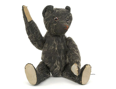 An extremely rare probably Terry's black mohair teddy bear, British